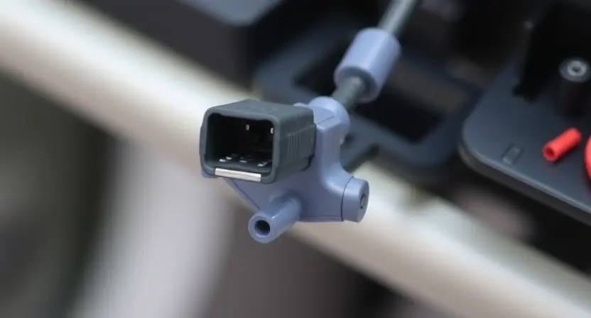 A close-up, detailed image of a car's steering angle sensor. The sensor should be clearly visible, with wires and connectors highlighted. The background should be blurred to emphasize the sensor. Focus on the sensor's physical components and any signs of damage or wear.